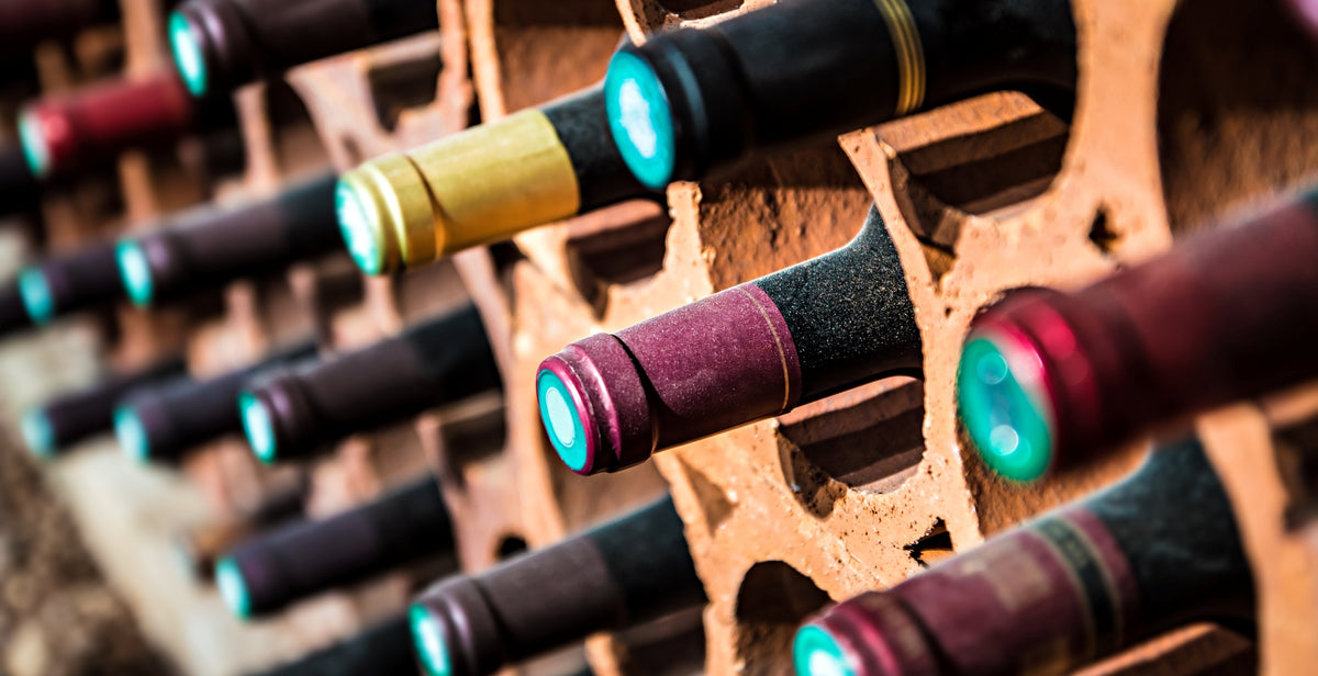 Fine wine bottles resting in a cellar rack
